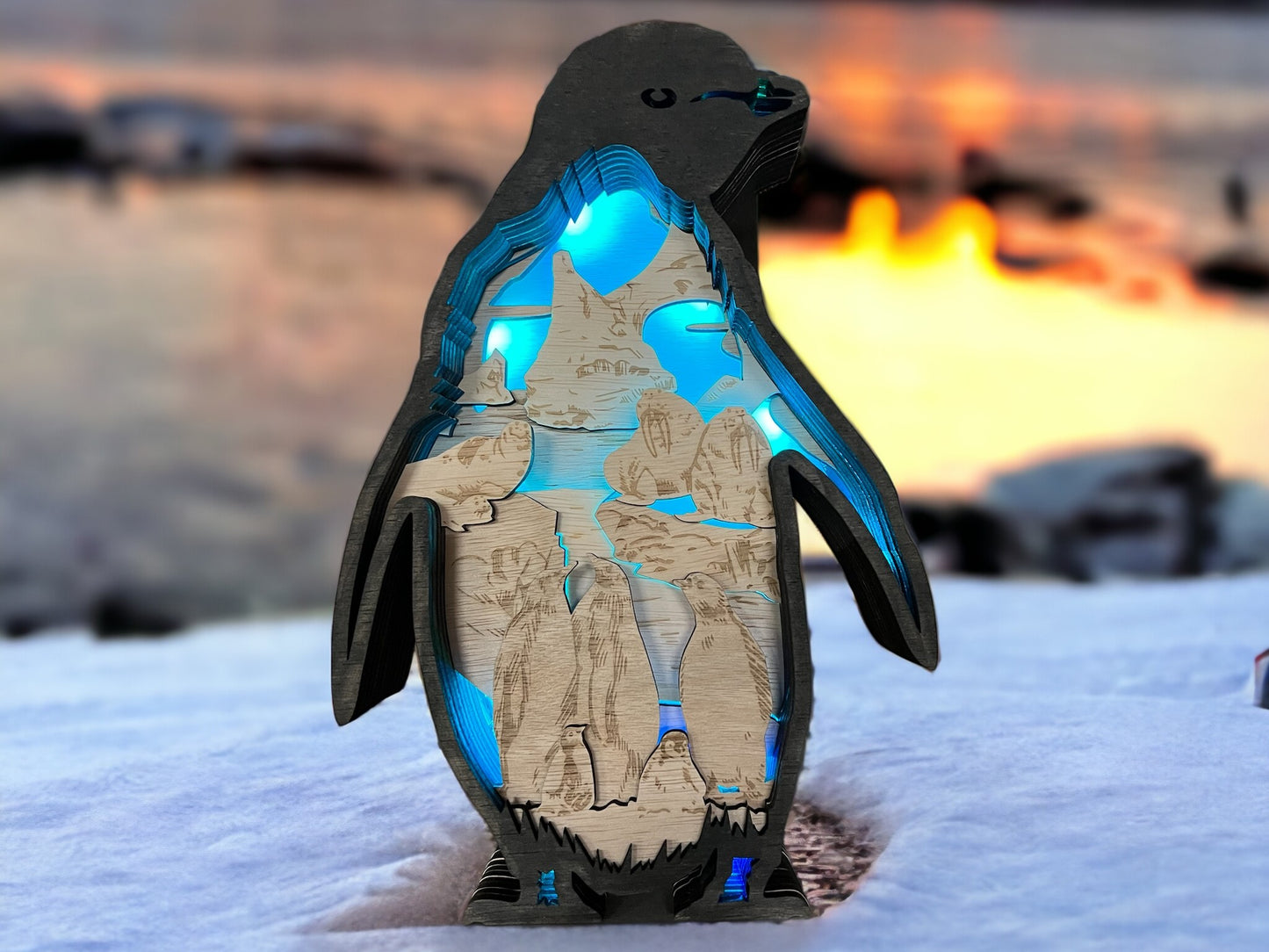 Caja de sombras 3D iluminada por pingüinos